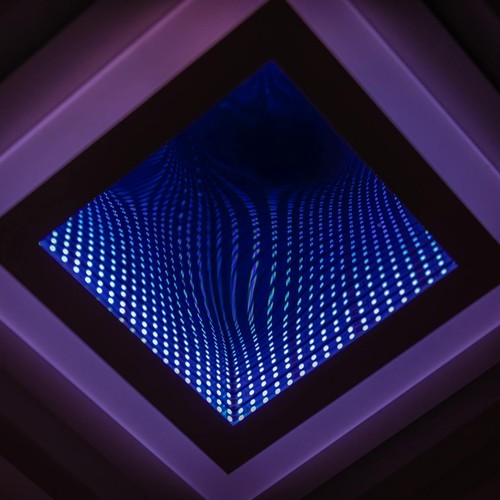 A captivating abstract view of a LED infinity mirror with vibrant light patterns.